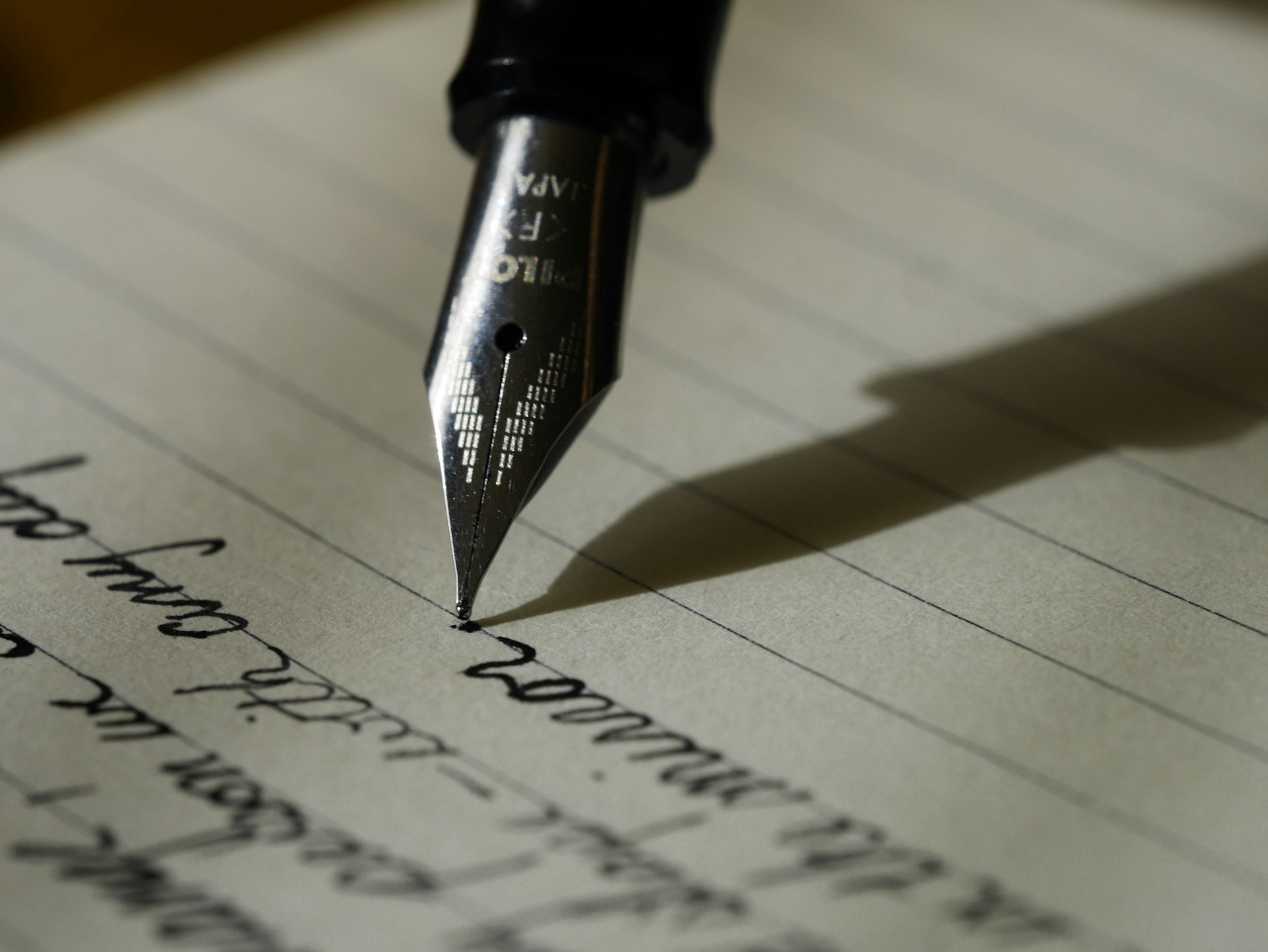 Open notebook and pen resting on a clean minimalist desk